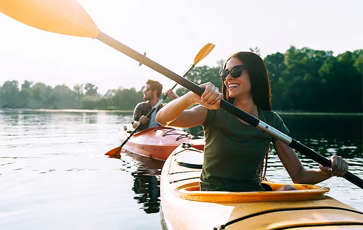 Couple kayaking on river