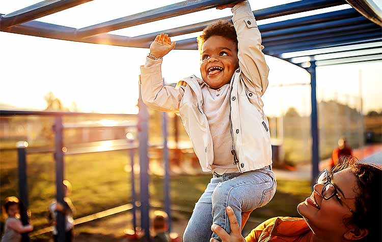 child and mother at the jungle gym