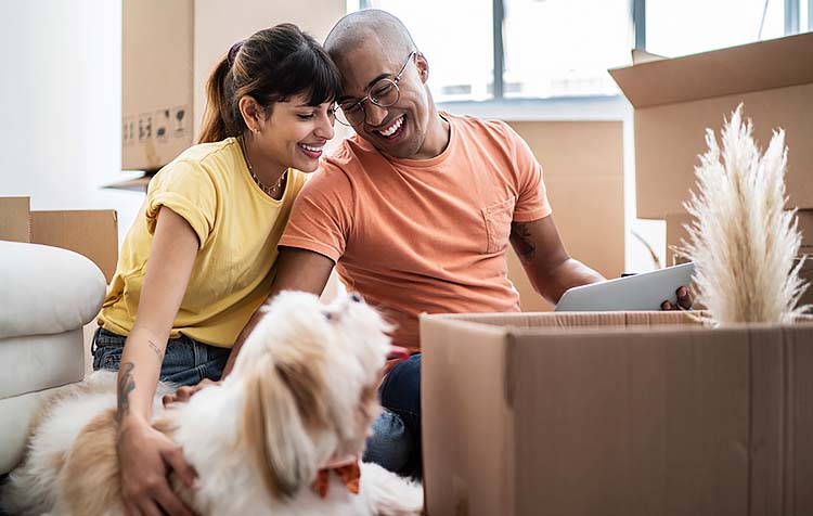Couple with dog in their new home