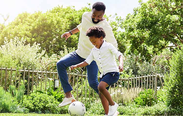Father and son playing soccer