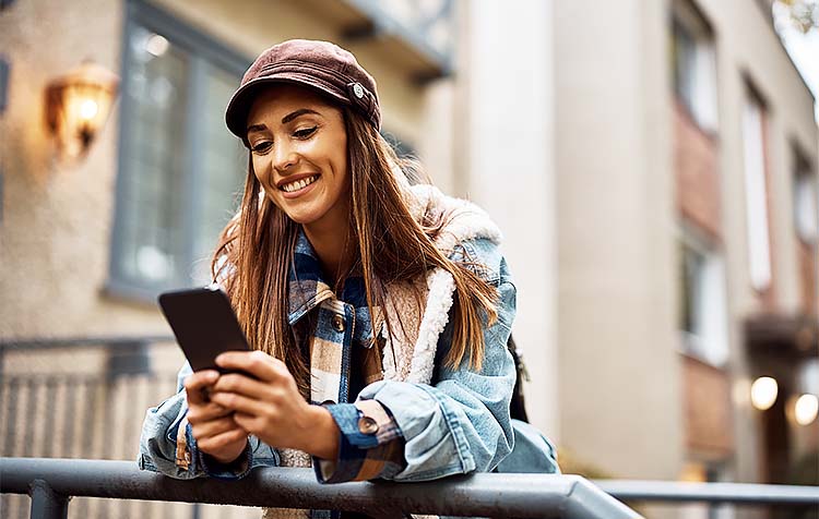 Happy girl smiling at phone