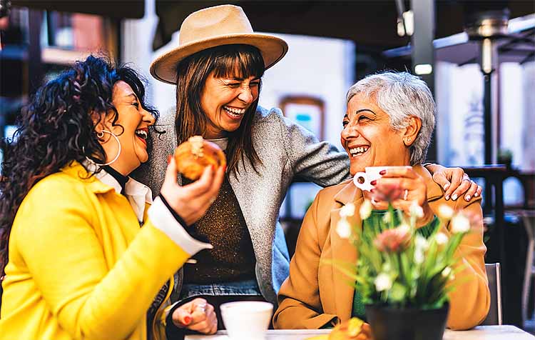 Happy older women at a cafe, laughing
