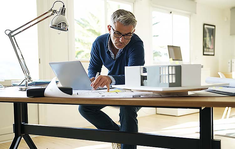 Architect in office working on construction project