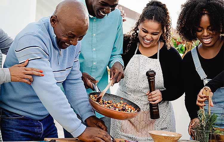 Happy African American family cooking together at home patio