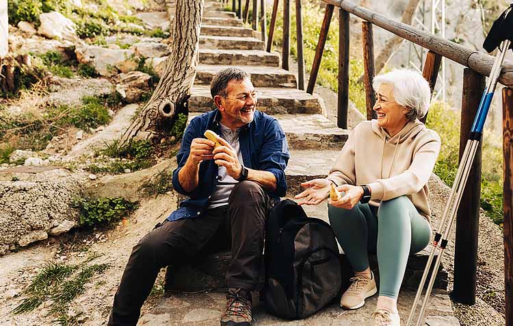 Older couple resting after hike outdoors