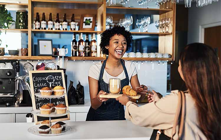 Woman paying with card at a coffee shop