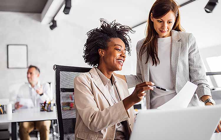 Woman showing something to another colleague.