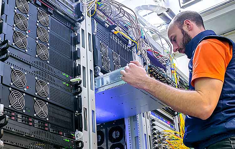 System administrator installs a new server in a modern data center
