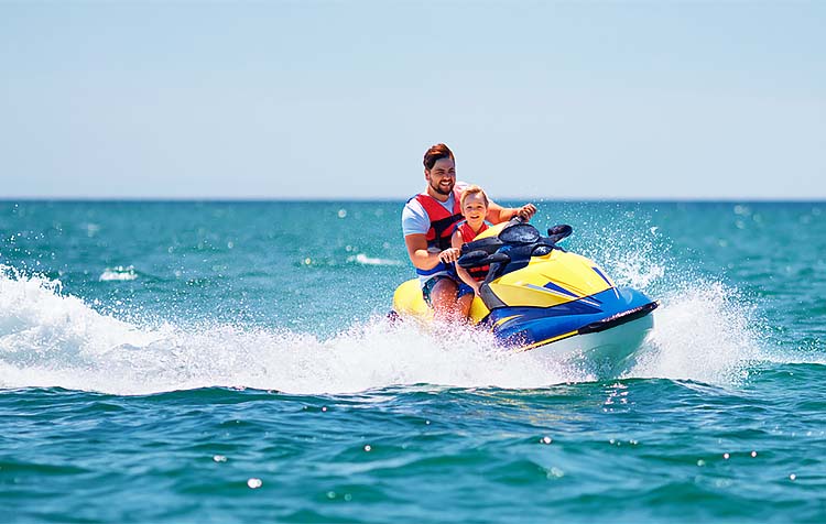 Father and son riding jet ski