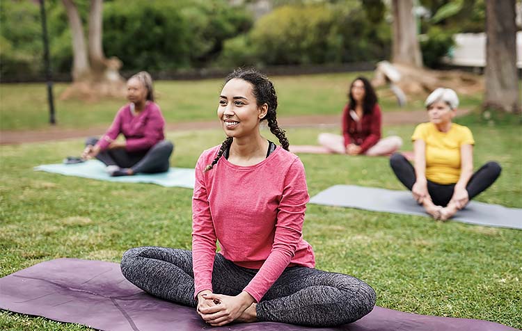Women of all ages participating in group yoga
